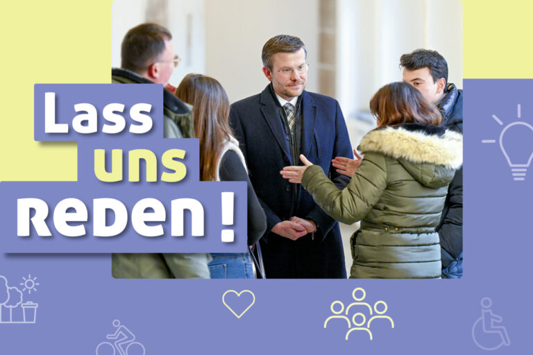 Bild des Oberbürgermeister Marcus König im Gespräch mit Menschen.